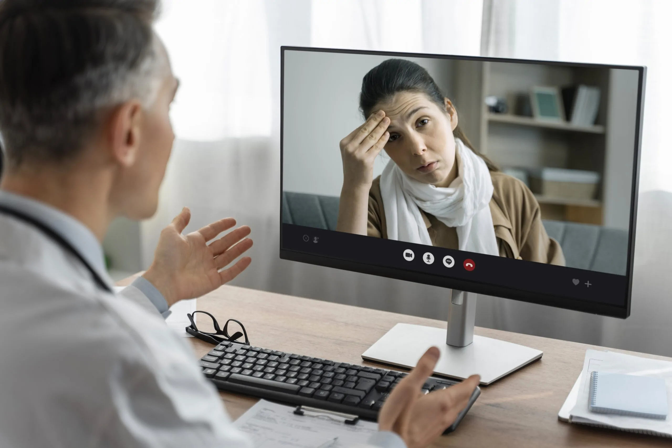 Psychiatrist discussing DEA telehealth changes with a patient during an online consultation